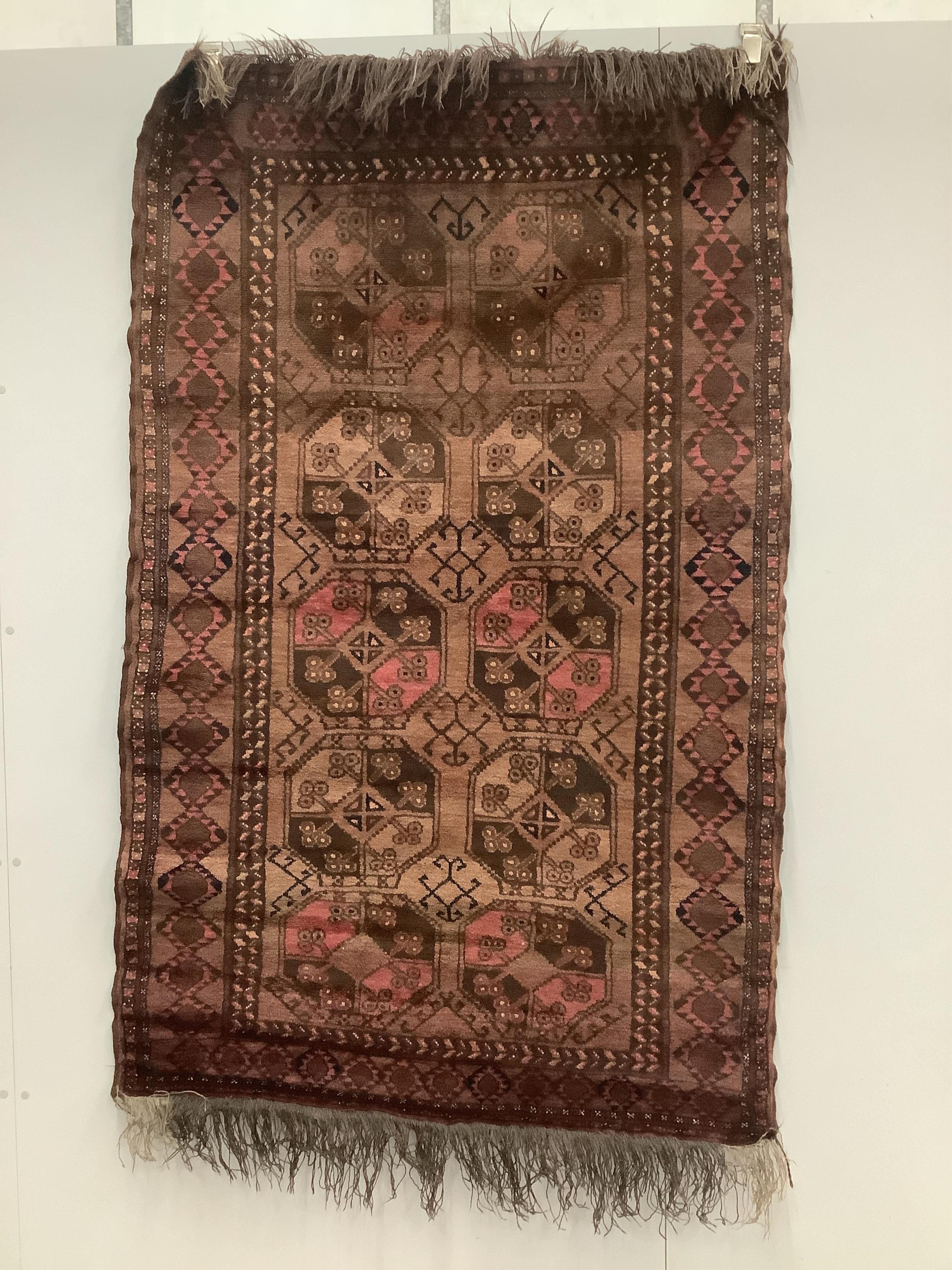 An Afghan red ground rug, 190 x 120cm. Condition - fair